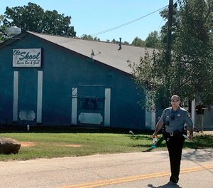 A Lancaster County Sheriff's deputy walks around the Old Skool Sports Bar and Grill, the scene of a shooting early in the morning, north of Lancaster, S.C. Lancaster County Sherriff's Office said in a statement that the agency was investigating a fatal shooting that also injured several people. (Photo/Jessica Holdman, The Post And Courier via AP)