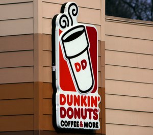 This Jan. 22, 2018, file photo shows the Dunkin' Donuts logo on a shop in Mount Lebanon, Pa. (AP Photo/Gene J. Puskar, File)
