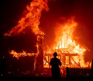 A home burns during a wildfire in Paradise, Calif. Gov. Gavin Newsom has signed nearly two-dozen laws aimed at preventing and fighting the devastating wildfires that destroyed the Sierra foothills city last fall. (Photo/AP. Noah Berger, File)