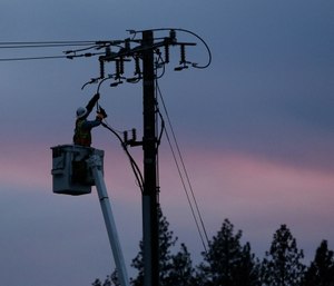 Pacific Gas & Electric lineman works to repair a power line in fire-ravaged Paradise, Calif. (AP Photo/Rich Pedroncelli)