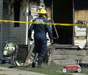 Erie Bureau of Fire Inspector Mark Polanski helping investigate a fatal fire at 1248 West 11th St. in Erie, Pa. (Greg Wohlford/Erie Times-News via AP)