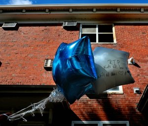 Balloons are seen at the scene of a Sunday fire in the Clinton-Peabody public housing complex in St. Louis. (Robert Cohen/St. Louis Post-Dispatch via AP)