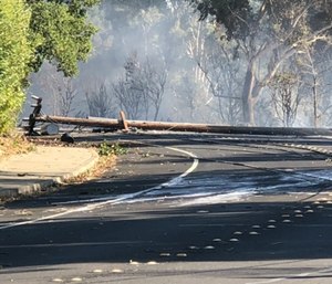In this photo taken Sunday, Oct. 27, 2019, are power lines in Lafayette, Calif., that show damage near where a fire started. (Matthias Gafni/San Francisco Chronicle via AP)