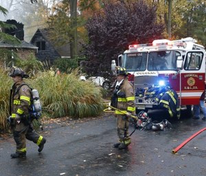 Woodbridge firefighters work the scene of fire after a plane crashed into a home Tuesday, Oct. 29, 2019, in Woodbridge, N.J. (AP Photo/Noah K. Murray)