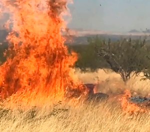 In this frame grab from a April 23, 2017, video provided by the U.S. Forest Service, is a gender reveal event in the Santa Rita Mountain's foothills, more than 40 miles southeast of Tucson, Ariz. The explosion from the reveal ignited the 47,000-acre Sawmill Fire. Gender reveal parties with a blast of color, pink or blue, that were once considered private gatherings have become social media spectacles, sometimes with dangerous consequences.