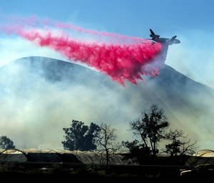 An air tanker drops retardant as the Maria Fire approaches Santa Paula, Calif.