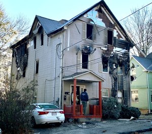 Investigators work the scene of an overnight fire that killed Lt. Jason Menard, Wednesday, Nov. 13, 2019 in Worcester, Mass. Menard, 39, and his crew became trapped on the top floor of the three-story home after the fire was reported at about 1 a.m., Worcester Fire Chief Michael Lavoie told a news conference. Menard helped two members of his crew escape but he himself was unable to get out.