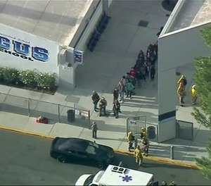 People are lead out of Saugus High School after reports of a shooting on Thursday, Nov. 14, 2019 in Santa Clarita, Calif. The Los Angeles County Sheriff’s Department says on Twitter that deputies are responding to the high school about 30 miles (48 kilometers) northwest of downtown Los Angeles. The sheriff’s office says a male suspect in black clothing was seen at the school. (Photo/KTTV-TV via AP)