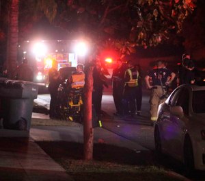 Police and emergency personnel work at the scene of a shooting at a backyard party, Sunday, Nov. 17, 2019, in southeast Fresno, Calif. Multiple people were shot and at least four of them were killed Sunday at a party in Fresno when suspects sneaked into the backyard and fired into the crowd, police said. (Photo/Larry Valenzuela, The Fresno Bee via AP)
