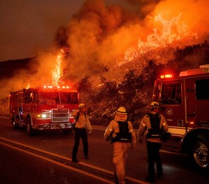 Firefighters battle the Cave Fire burn as it flares up along Highway 154 in the Los Padres National Forest, above Santa Barbara, Calif., Tuesday, Nov. 26, 2019. (Photo/AP, Noah Berger)
