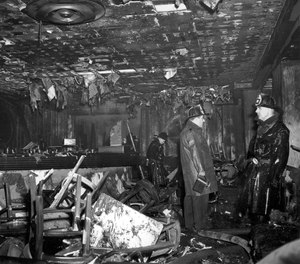In this Nov. 28, 1942 file photo, firefighters inspect the ruins of the Cocoanut Grove nightclub in Boston, where 492 people died in a fire. A 2019 documentary film,