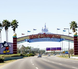 In this Jan. 31, 2017, file photo, cars travel one of the roads leading to Walt Disney World in Lake Buena Vista, Fla.
