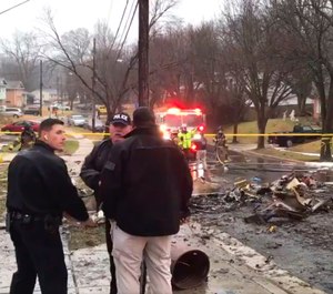 Firefighters and police officers investigate the scene of a small plane crash in the Lanham neighborhood, Md. (Photo/Prince George's County Fire/EMS)