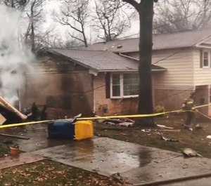 A firefighter walks around the scene of a small plane crash in the Lanham neighborhood of Maryland Dec. 29, 2019. The small plane crashed in the Maryland suburbs of the nation's capital Sunday, hitting a home's carport and killing at least a person aboard the aircraft, authorities said. (Photo/Prince George's County Fire/EMS)