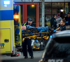 Paramedics transport a stabbing victim in Austin, Texas, on Friday, Jan. 3, 2020. (Jay Janner/Austin American-Statesman via AP)
