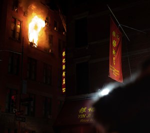 Fire blows out of a window in the Chinatown section of New York, Thursday, Jan. 23, 2020. New York City firefighters battled a raging blaze at a building in the city's Chinatown area Thursday night, Firefighters said they were called about 8:45 p.m. to 70 Mulberry Street for a fire on the fourth and fifth floors of the building, FDNY officials said. (Photo/Robert Bumsted)