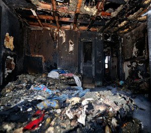 Burned clothes and the interior of a house are destroyed from a fatal fire on Saturday, Feb. 8, 2020 in Clinton, Miss. Authorities say a mother and her six children have been killed in the house fire. (AP Photo/Rogelio V. Solis)