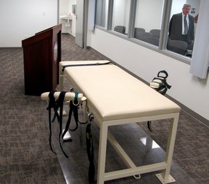 This Oct. 20, 2011, file photo, shows the execution chamber at the Idaho Maximum Security Institution as Security Institution Warden Randy Blades look on in Boise, Idaho.