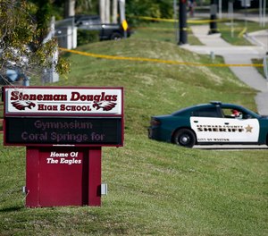 In this Feb. 15, 2018, file photo, a Broward County sheriff's deputy blocks the entrance to Marjory Stoneman Douglas High School in Parkland, Fla., following a deadly shooting at the school.