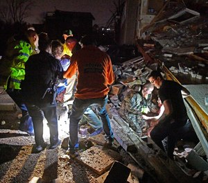 Rescue workers free two survivors from their home that collapsed, trapping them under rubble after a tornado hit area Tuesday, March 3 2020, in Mt. Juliet, Tenn.