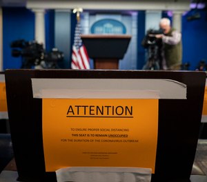 Signs in the briefing room of the White House indicate social distancing measures being taken to separate reporters working at the White House, Monday, March 16, 2020, in Washington.
