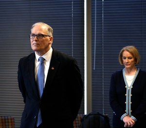 Wash. Gov Jay Inslee is seen with Seattle Mayor Jenny Durkan at a news conference. Durkan announced a similar vaccine mandate for city and county employees.