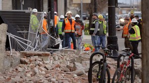 Construction workers looks at the rubble from a building after an earthquake Wednesday, March 18, 2020, in Salt Lake City. Image: AP Photo/Rick Bowmer