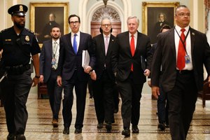 Treasury Secretary Steven Mnuchin, left, accompanied by White House Legislative Affairs Director Eric Ueland and acting White House chief of staff Mark Meadows, walks to the offices of Senate Majority Leader Mitch McConnell of Ky. on Capitol Hill in Washington, Tuesday, March 24, 2020. Image: AP Photo/Patrick Semansky