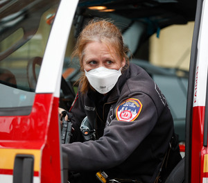 An FDNY provider wears personal protective equipment outside a COVID-19 testing site at Elmhurst Hospital Center in New York.