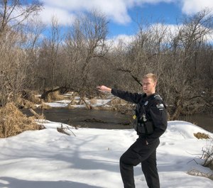 In this March 5, 2020 photo, Wisconsin Department of Natural Resources Warden Austin Schumacher stands on the edge of a marsh in Edgerton, Wis., where a 13-year-old boy disappeared after running away from school in November 2019. This month, Schumacher received the DNR’s Lifesaving Award. (AP Photo/Todd Richmond)