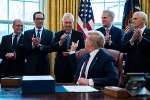 President Donald Trump hands a pen to Senate Majority Leader Mitch McConnell of Ky., after signing the coronavirus stimulus relief package in the Oval Office at the White House, Friday, March 27, 2020, in Washington. Image: AP Photo/Evan Vucci