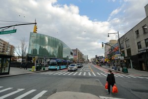 A woman wearing personal protective equipment crosses Main Street Wednesday, April 1, 2020, in the Flushing section of the Queens borough of New York. Image: AP Photo/Frank Franklin II