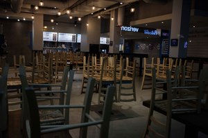 Chairs hang stacked on empty tables at a closed restaurant in New York. Small business owners across the country are waiting to receive loan money under the government’s $2 trillion coronavirus relief program. Image: AP Photo/Yuki Iwamura
