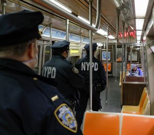 NYPD officers walk the A-train station, Thursday, April 30, 2020, in the Manhattan borough of New York.