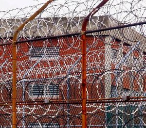 A security fence surrounds inmate housing on the Rikers Island correctional facility in New York. (AP Photo/Bebeto Matthews)