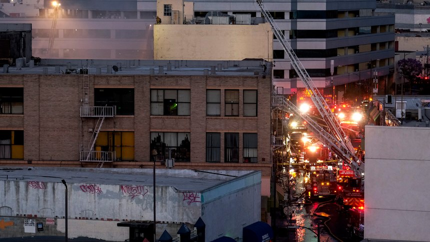 Los Angeles Fire Department firefighters work the scene of a structure fire that injured multiple firefighters, according to a fire department spokesman, Saturday, May 16, 2020, in Los Angeles.