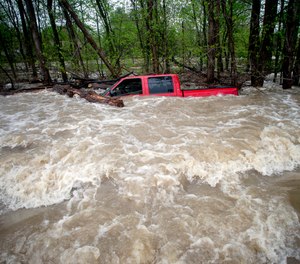 Tittabawassee Fire and Rescue rescued the driver from this red pickup truck in Saginaw County, Mich. The truck was swept off of the road by standing water.