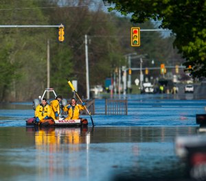 A search and rescue boat is deployed as floodwater rises in Midland, Mich., Wednesday, May 20, 2020. A Michigan EMT who survived COVID-19 lost his home during the historic floods after the Edenville Dam was breached. (Photo/Katy Kildee, Midland Daily News via AP)