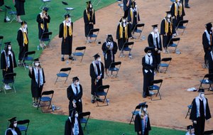 Seniors from Spain Park High School stand on a baseball field at a socially distanced graduation ceremony in Hoover, Ala., Wednesday, May 20, 2020. Health officials say usual graduation ceremonies could endanger the public health by promoting the spread of disease. But school officials say they're using social distancing guidelines and abiding by state health rules. Image: AP Photo/Jay Reeves