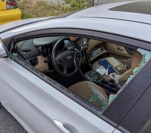 This Thursday, May 21, 2020, photo shows a parked car with a broken driver's side window after a smash-and-grab break-in in Los Angeles. (AP Photo/Damian Dovarganes)