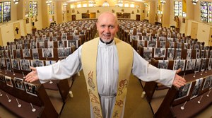 In this May 22, 2020, photo, the Rev. Nicolas Sanchez Toledano poses among pews adorned with portraits of his parishioners at St. Patrick's Catholic Church during the coronavirus outbreak in the North Hollywood section of Los Angeles. Image: AP Photo/Mark J. Terrill
