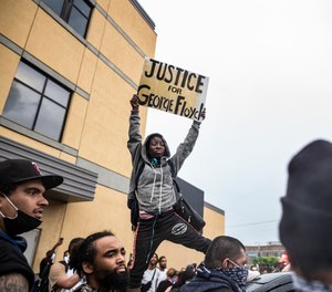 Protesters gather near the Minnesota Police 3rd Precinct Tuesday, May 26, 2020, in response to the death of George Floyd in police custody.