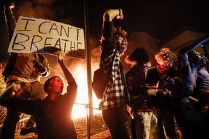 Protestors demonstrate outside of a burning Minneapolis 3rd Police Precinct, Thursday, May 28, 2020, in Minneapolis. Protests over the death of George Floyd, a black man who died in police custody Monday, broke out in Minneapolis for a third straight night. Image: AP Photo/John Minchillo