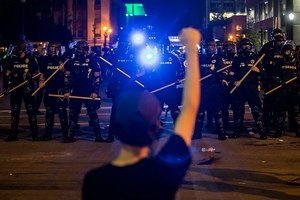 Police hold off protesters for Breonna Taylor, early Friday, May 29, 2020 in Louisville, Ky. Taylor, a black woman, was fatally shot by police in her home in March. Image: Michael Clevenger/Courier Journal via AP