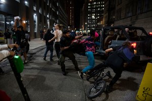 a police officer grabs a protester during a rally calling for an end to police violence and justice for George Floyd in Detroit. Image: Nicole Hester/Mlive.com/Ann Arbor News via AP