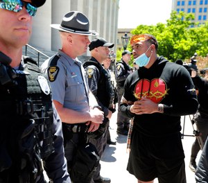 Jalon Lewis talks with Ohio State Trooper Weaver (no first name given) at the Ohio Statehouse in Columbus during a peaceful Sunday, May 31, 2020 protest over the death of George Floyd in Minnesota.