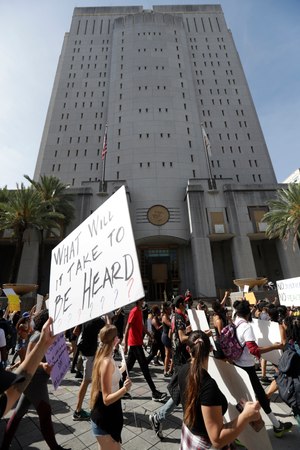 Protesters in the death of George Floyd march past the Federal Detention Center in Miami. AFGE Local 501 officials are making details about dire working conditions at the facility public in the hope of garnering support to spark change.