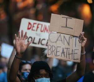 A protester holds a sign reading