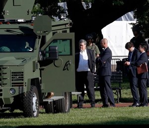 Attorney General William Barr, center, stands in Lafayette Park across from the White House as demonstrators gather to protest the death of George Floyd, Monday, June 1, 2020, in Washington.