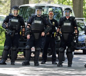 Cleveland police keep watch during a rally Tuesday, June 2, 2020, in Cleveland.